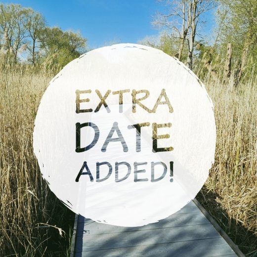 A white circle with the words 'extra date added' is layered on top of an image of the new wide boardwalk surrounded by reeds
