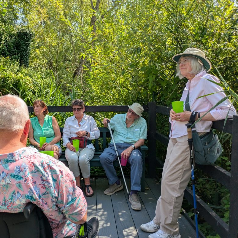 MIGGS members enjoying a welcome drink on a blazing hot August summer's day, in the area next to the Kingfisher hide. Previously this area was inaccessible to people who use wheelchairs and mobility aids.